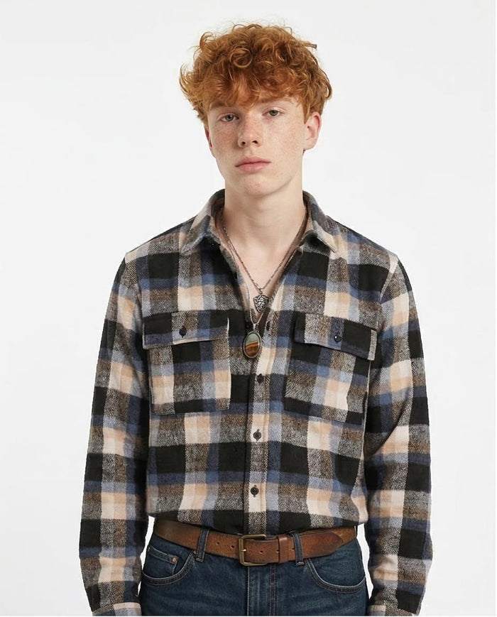 Person wearing a plaid shirt with a plain background