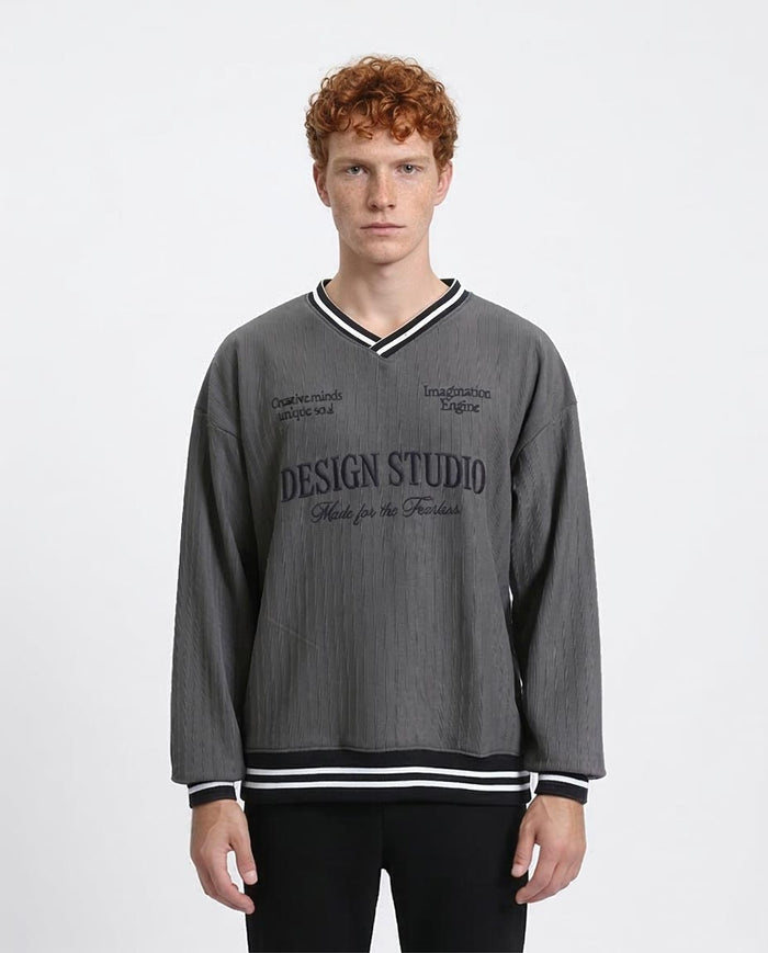 Man wearing a gray sweatshirt with text on a white background