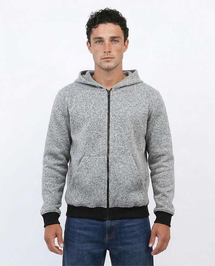 Man wearing a gray zip-up hoodie on a white background