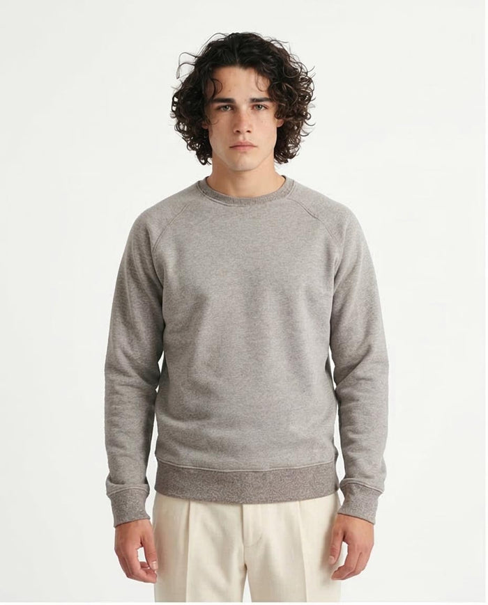Man wearing a gray sweatshirt against a plain background