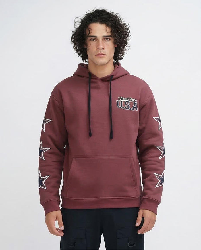 Man wearing a maroon hoodie with star designs and text on a white background