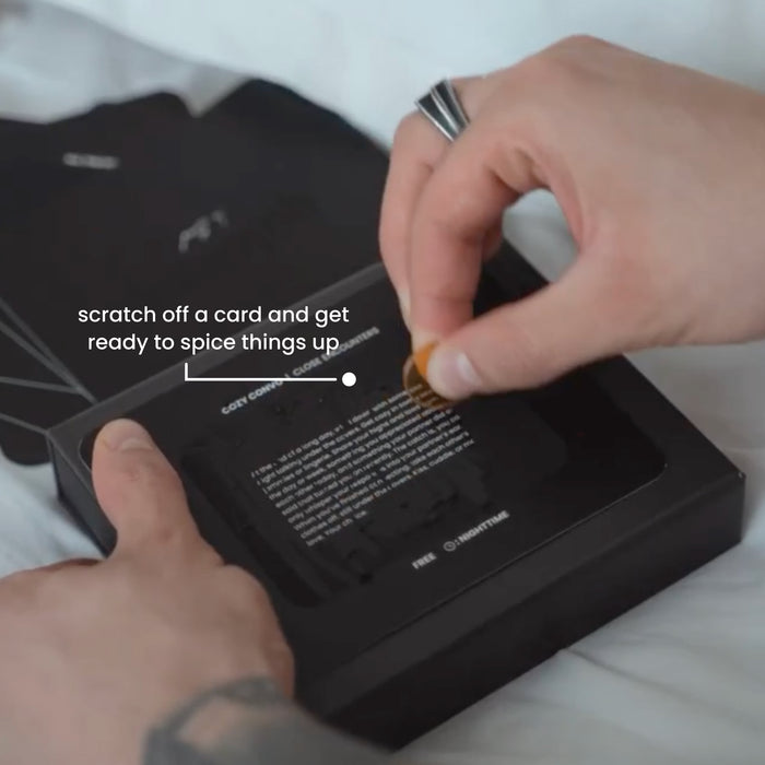 Close-up of a person scratching off a Quickies adventure card to reveal a surprise date night challenge.