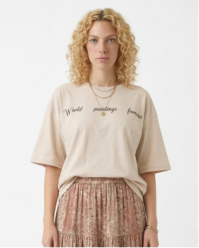 Woman wearing a beige t-shirt with text on a white background