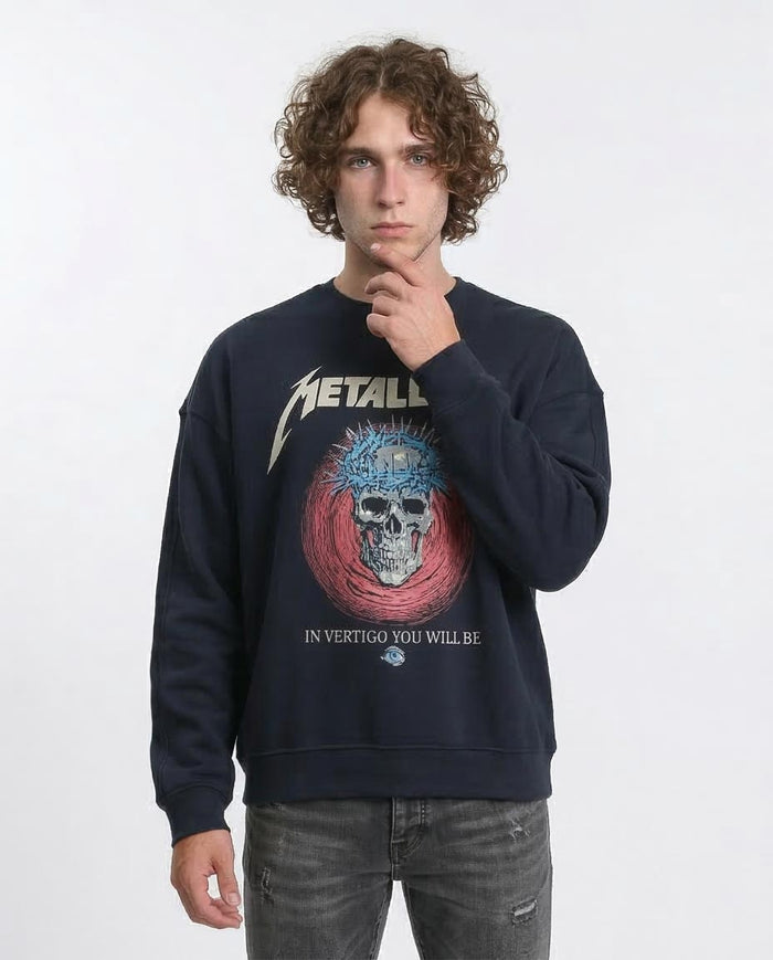 Person wearing a navy blue sweatshirt with a graphic design and text, on a white background