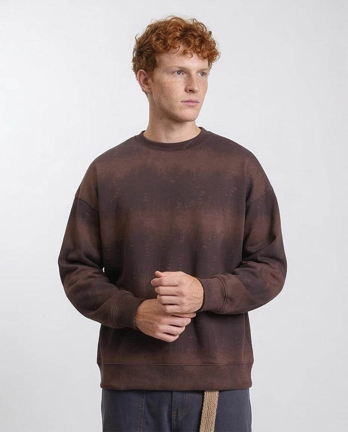 Man wearing a brown sweatshirt against a white background