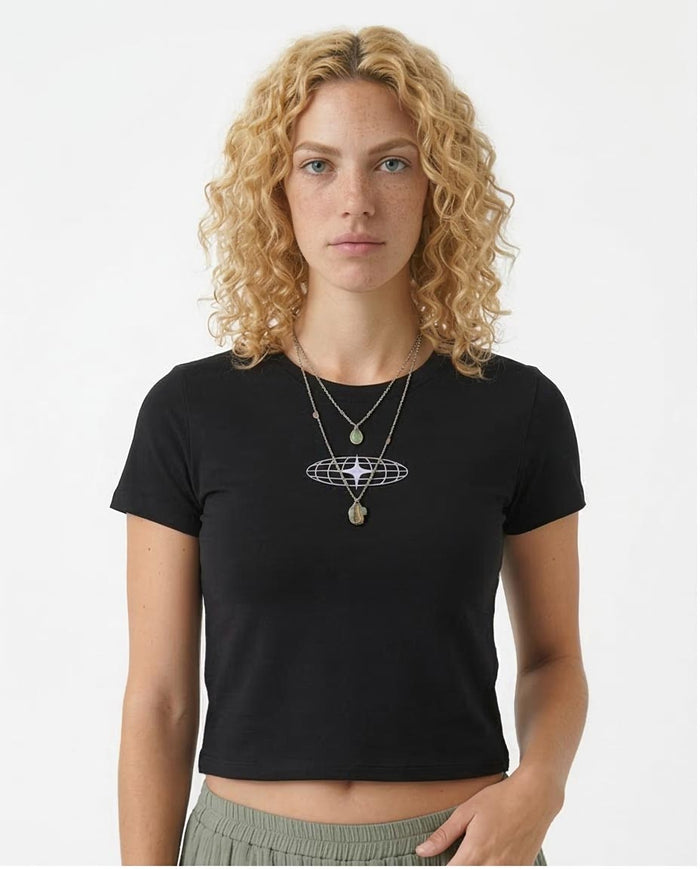 Woman wearing a black t-shirt with a white graphic design on a plain background