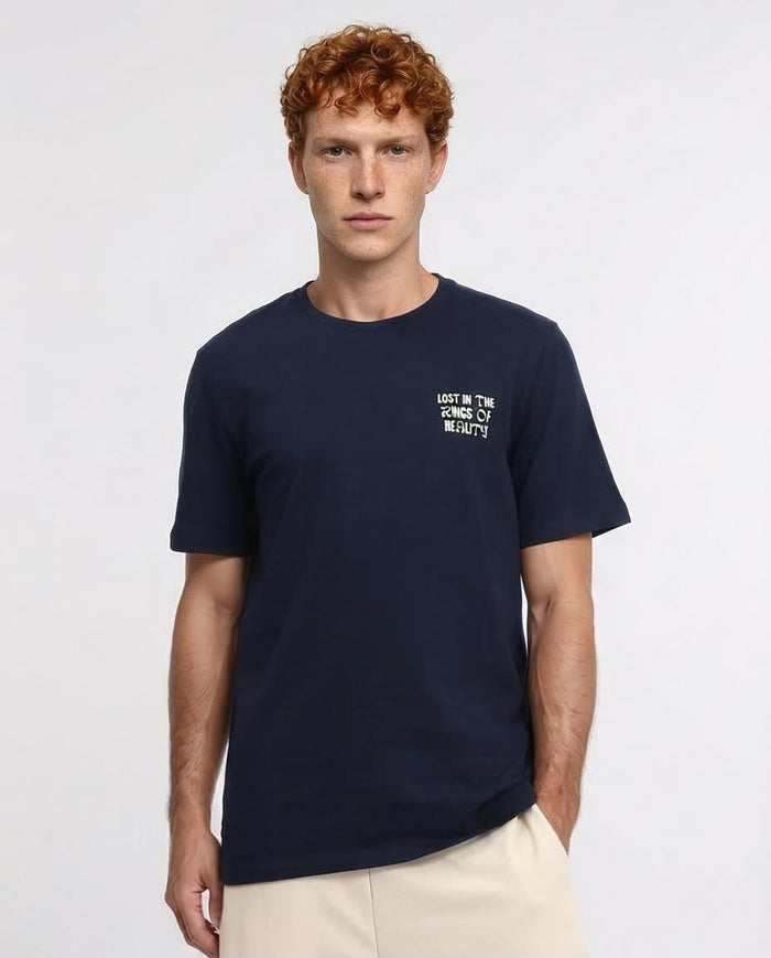 Man wearing a navy blue t-shirt with text on a white background