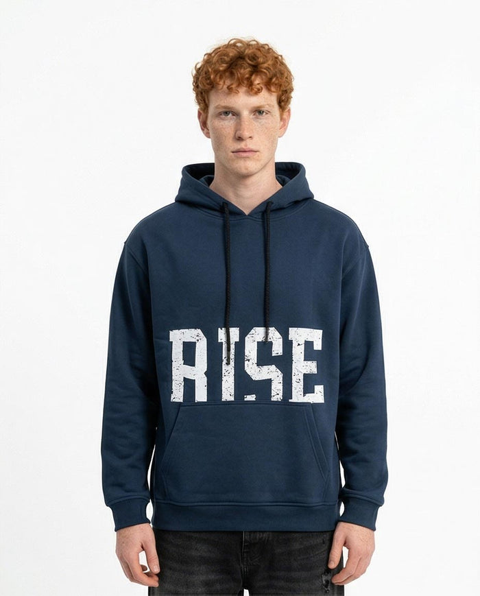 Person wearing a navy hoodie with 'RISE' printed on it against a white background