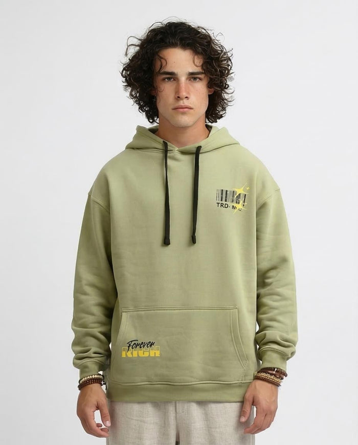 Person wearing a light green hoodie with text and graphics on a white background