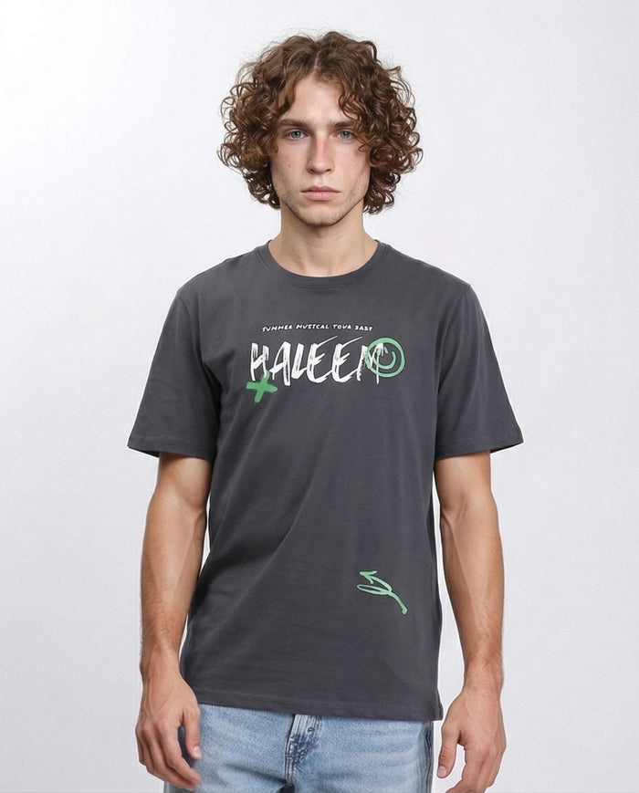 Man wearing a dark gray t-shirt with a logo and text on a white background