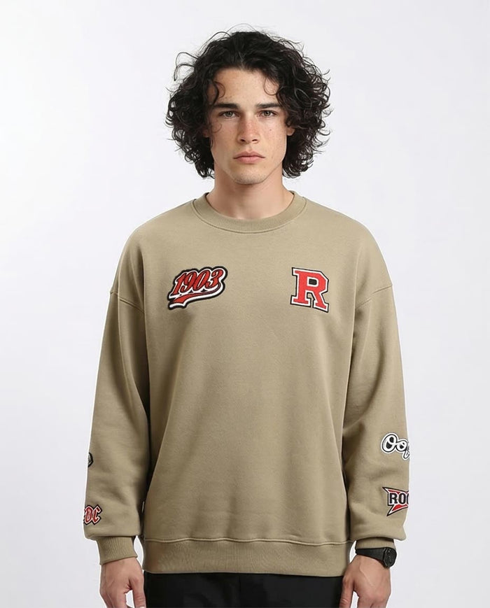 Man wearing a beige sweatshirt with logos on a white background
