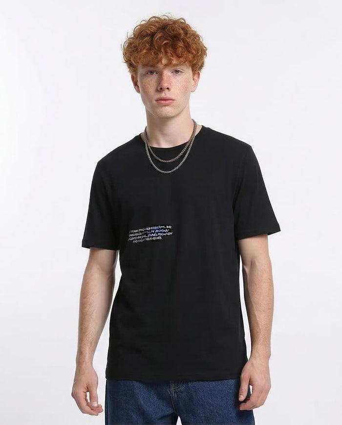Person wearing a black t-shirt with text on a white background
