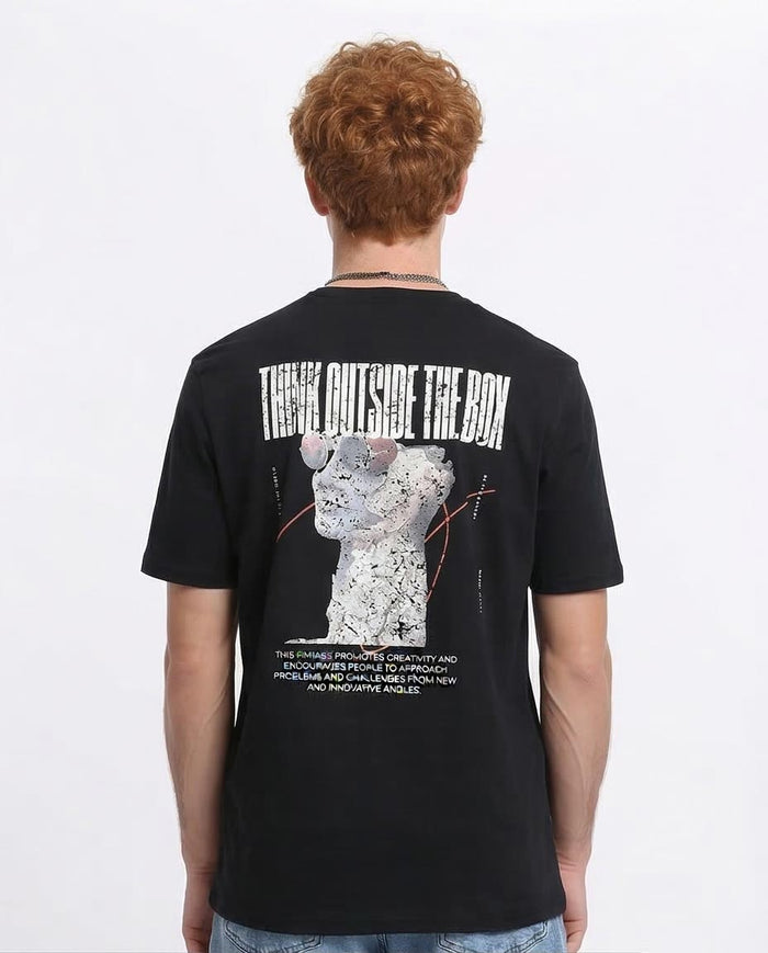 Person wearing a black t-shirt with a graphic design and text on the back, on a white background