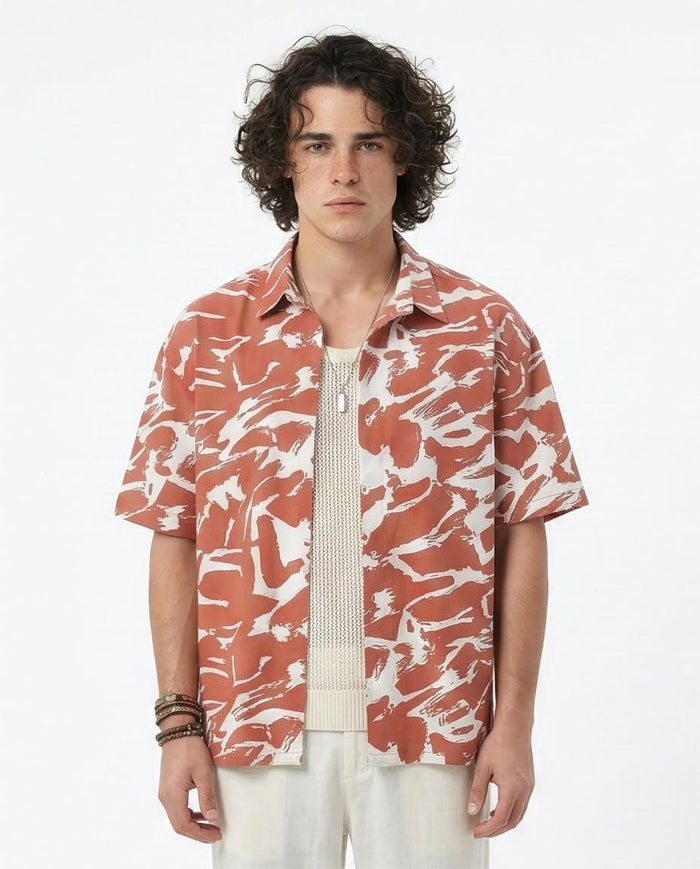 Man wearing a patterned shirt with a white background