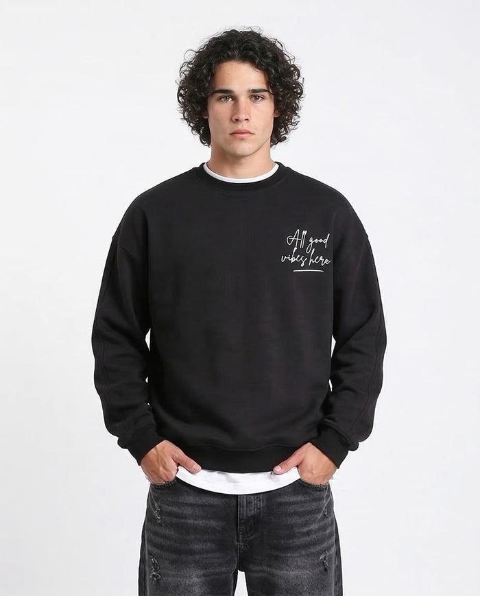 Person wearing a black sweatshirt with text on a white background