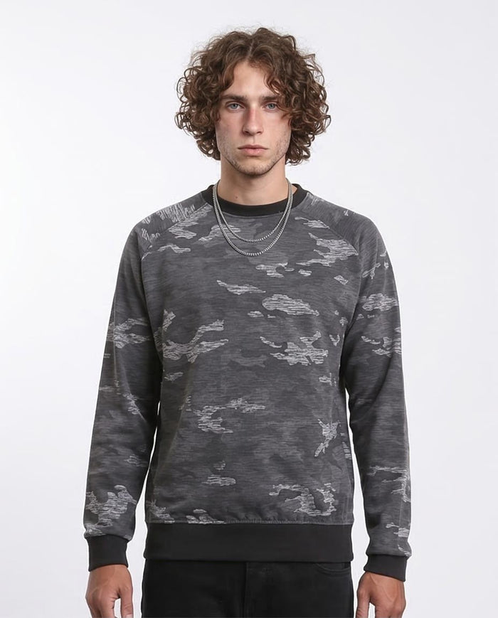 Man wearing a gray camouflage sweatshirt on a white background