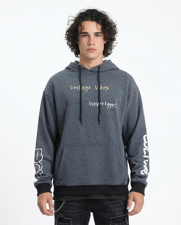 Person wearing a gray hoodie with text on a white background