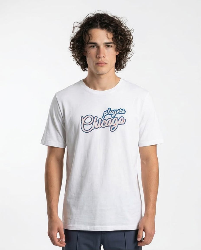 Person wearing a white t-shirt with 'Chicago' text on a plain background