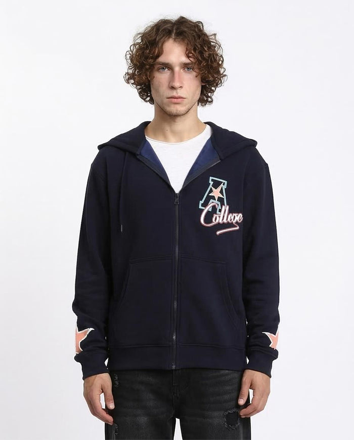 Person wearing a navy blue hoodie with a logo on a white background