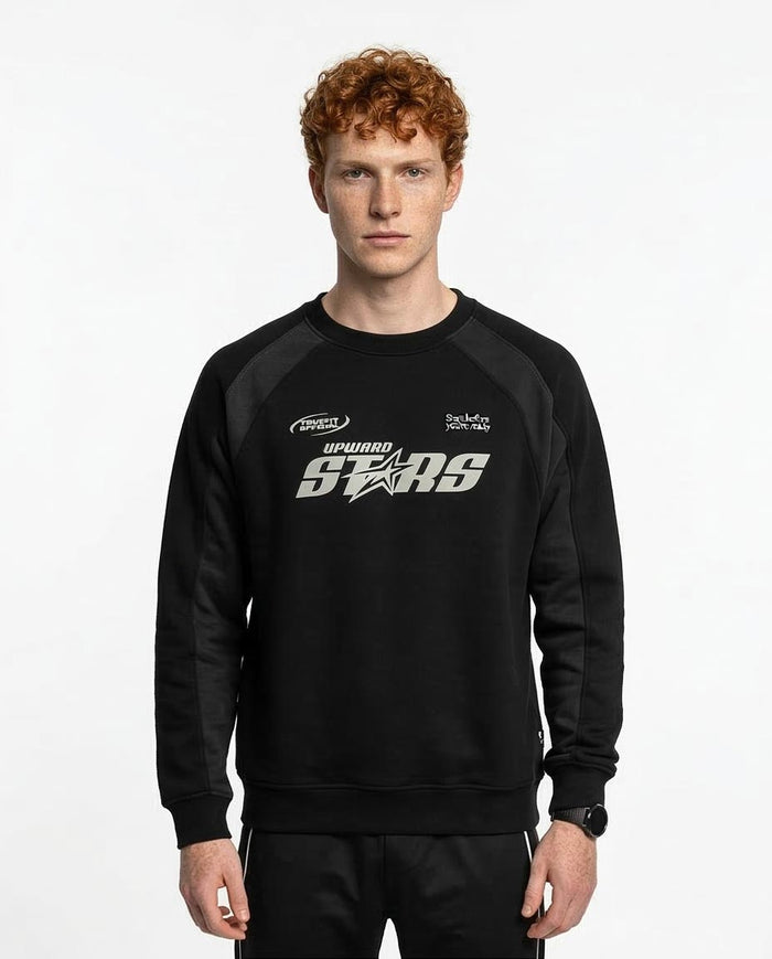 Man wearing a black sweatshirt with logos on a white background