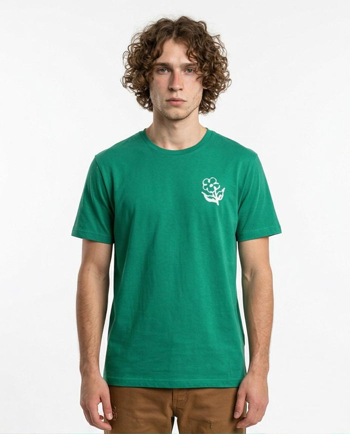 Man wearing a green t-shirt with a white logo on a white background