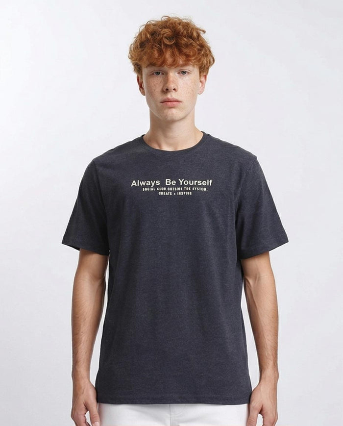 Person wearing a dark blue t-shirt with text on a white background