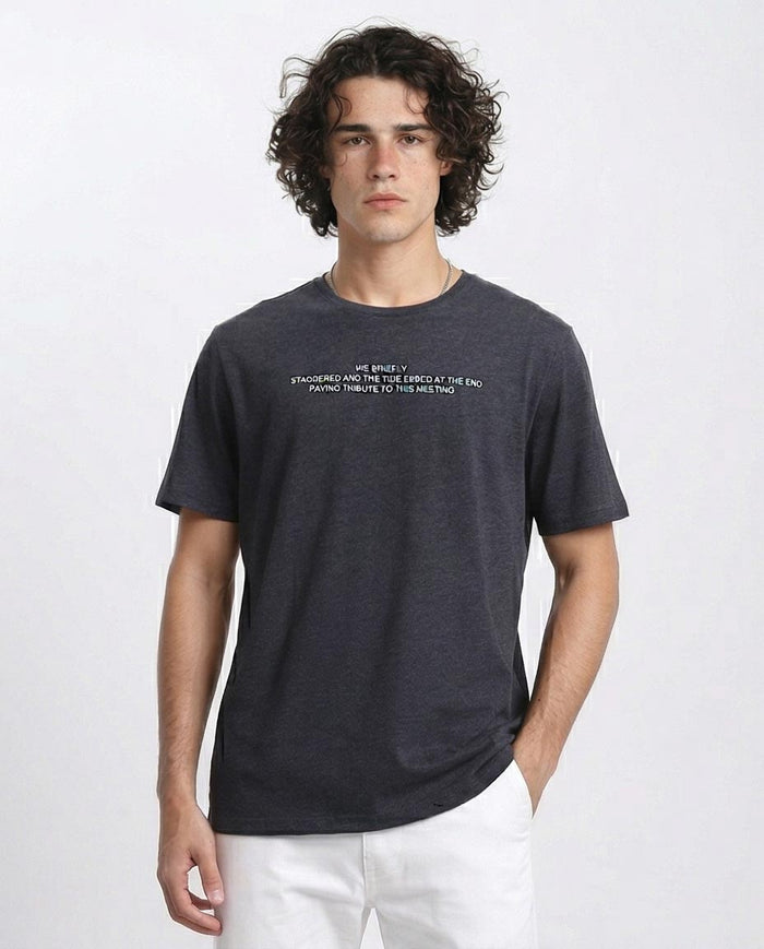 Man wearing a dark gray t-shirt with text on a white background