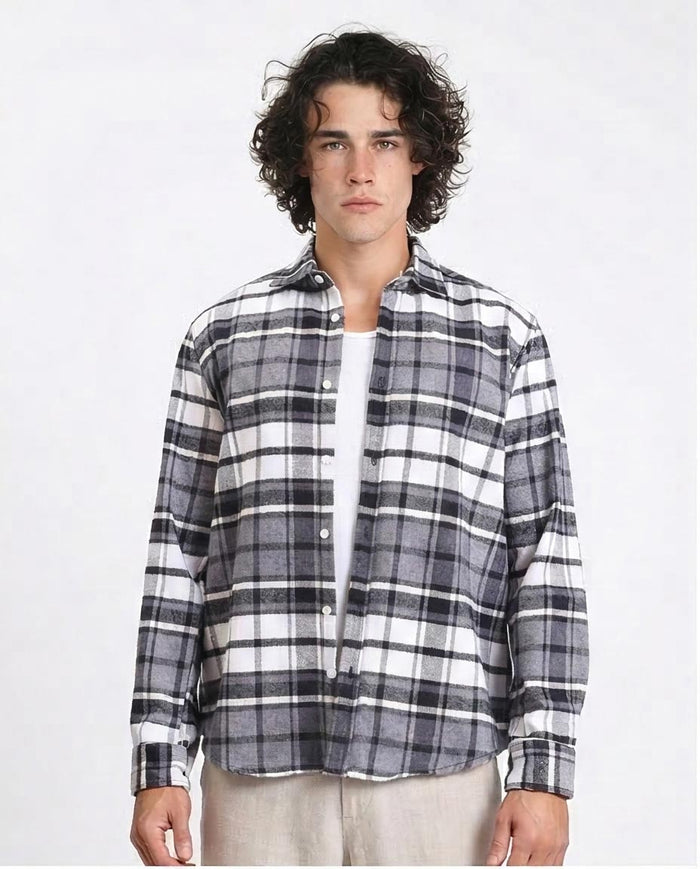 Man wearing a black and white plaid shirt on a white background