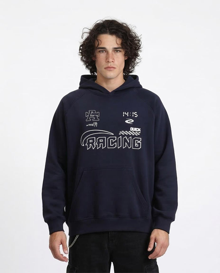 Person wearing a navy blue hoodie with racing-themed graphics on a white background