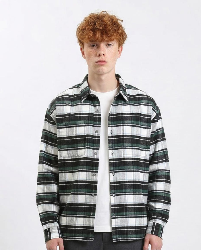 Man wearing a black and white plaid shirt over a white t-shirt on a white background