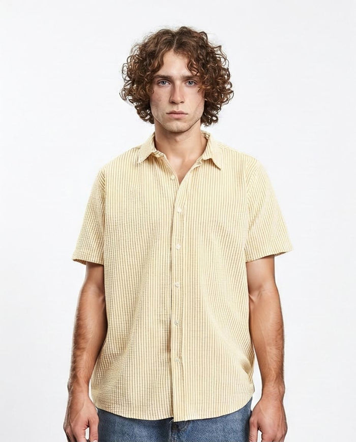 Man wearing a yellow striped shirt against a white background