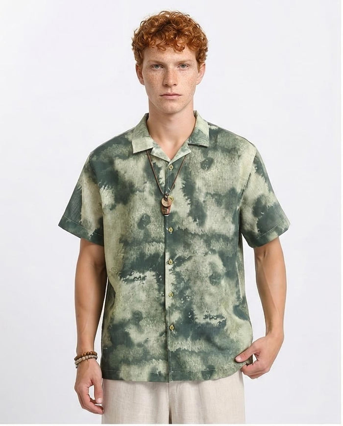Man wearing a green tie-dye shirt on a white background