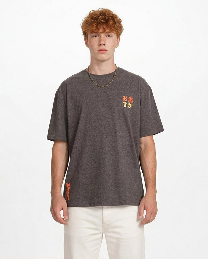 Man wearing a dark gray t-shirt with colorful text on a white background