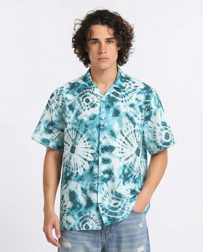 Man wearing a blue tie-dye shirt on a white background