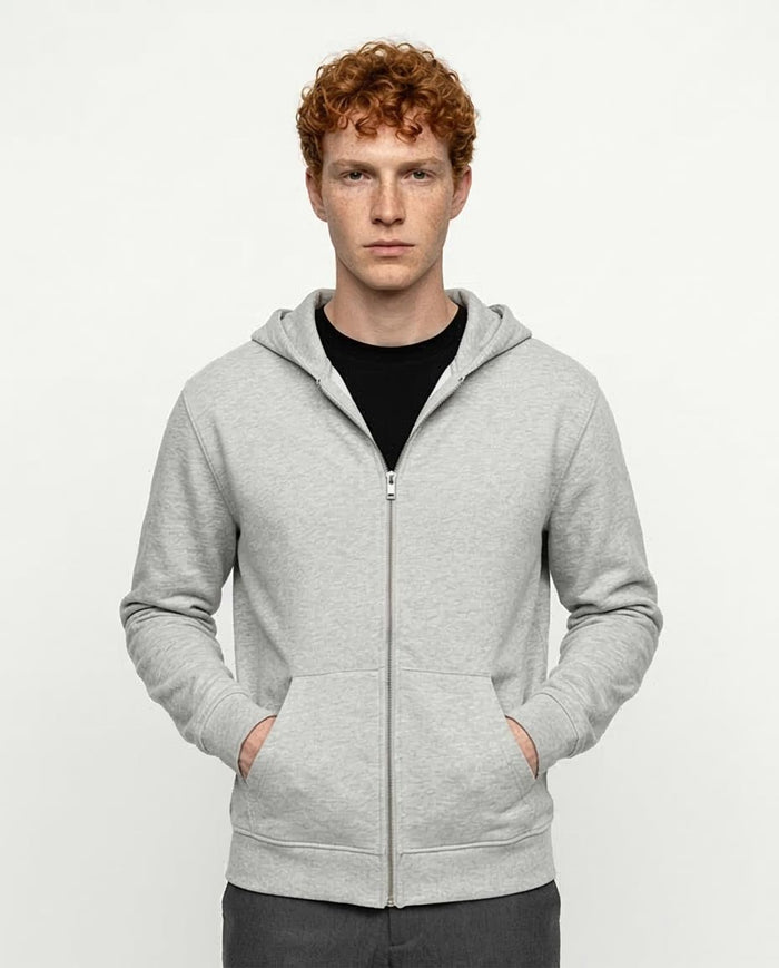 Man wearing a gray hoodie on a white background