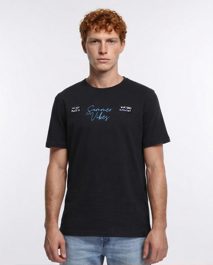 Man wearing a black t-shirt with text on a white background