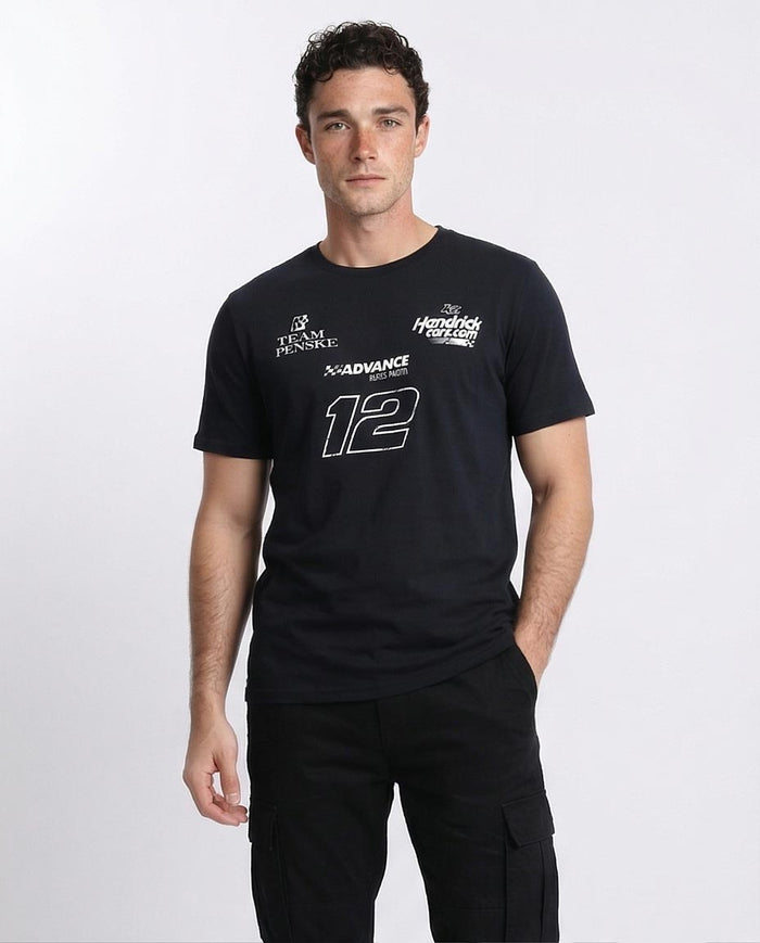 Man wearing a black t-shirt with logos and numbers on a white background