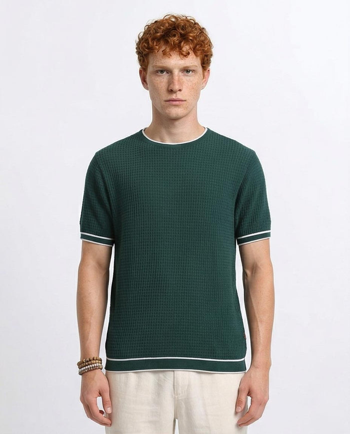 Man wearing a green textured shirt with white trim on a light gray background