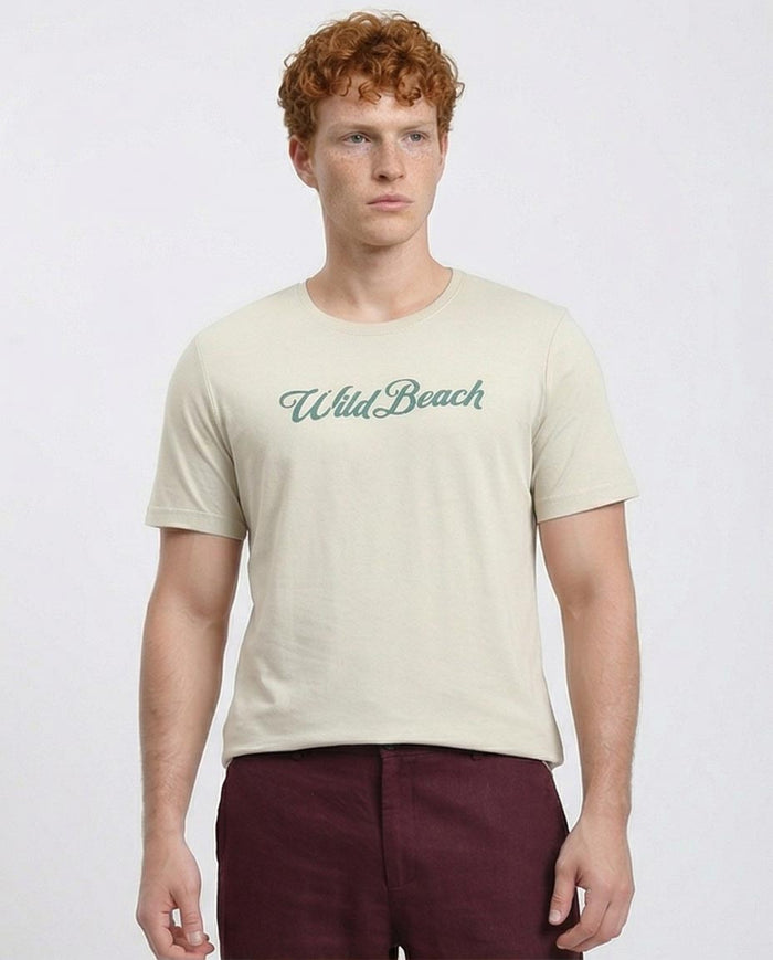 Man wearing a beige t-shirt with 'Wild Beach' text on a plain background