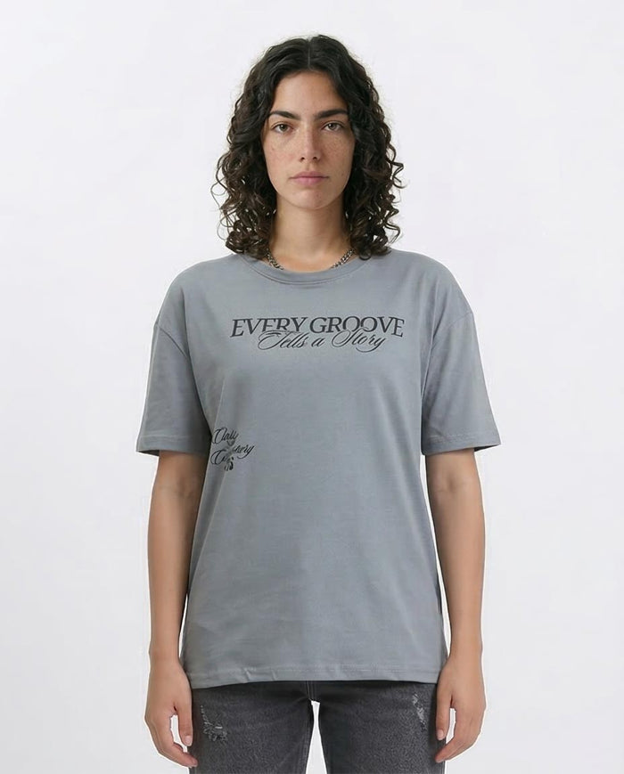 Woman wearing a gray t-shirt with text on a white background
