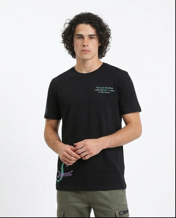 Person wearing a black t-shirt with text and graphics on a white background