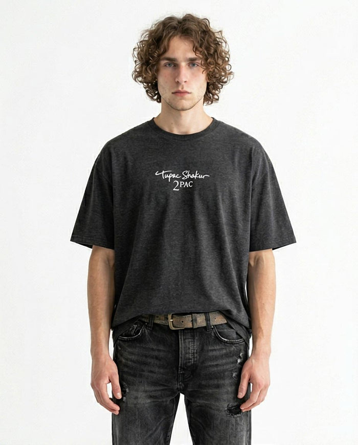 Person wearing a black t-shirt with text on a white background