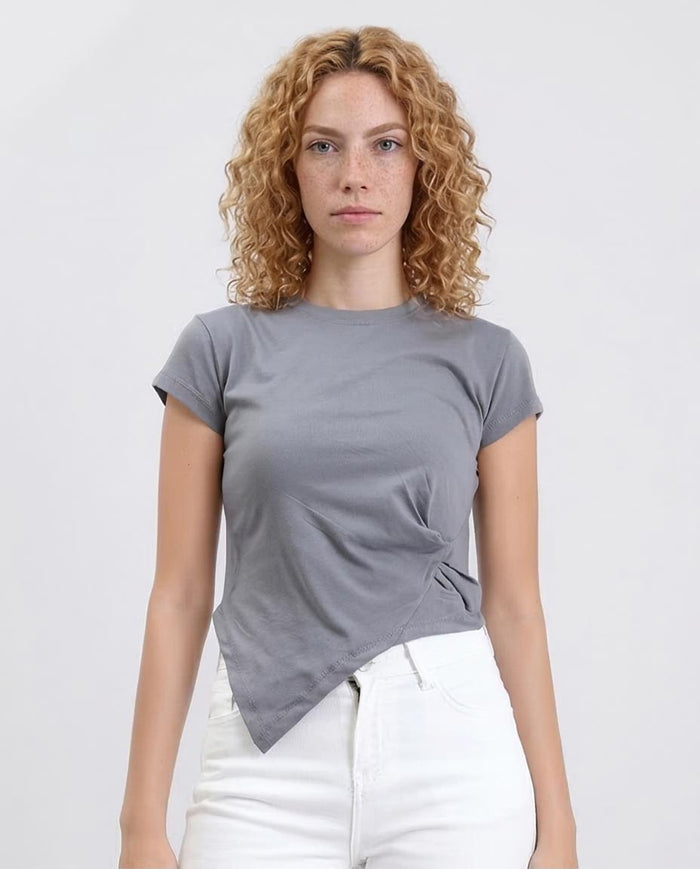 Woman wearing a gray t-shirt with a knot detail on a white background