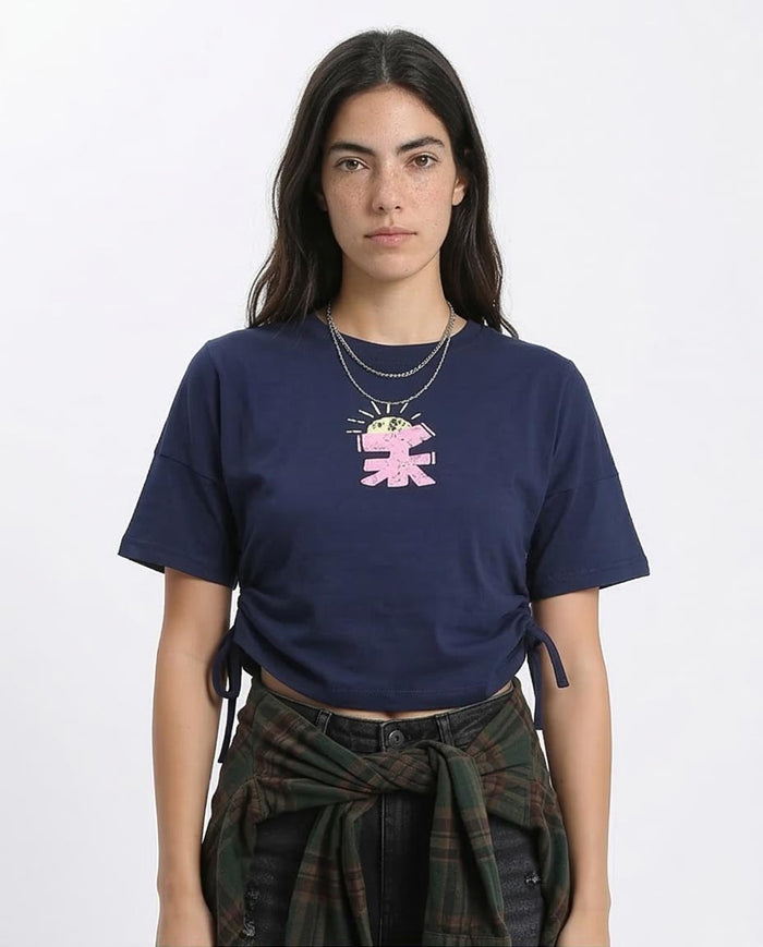 Woman wearing a navy blue t-shirt with a graphic design on a white background