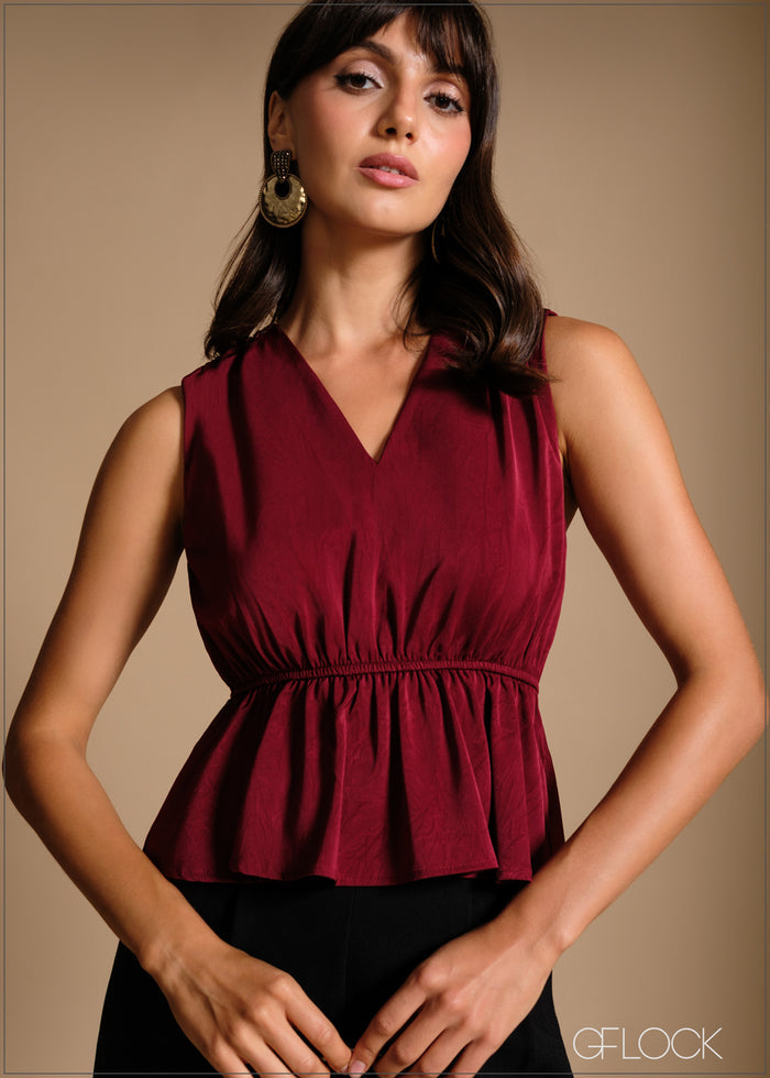 Gathered waist sleeveless peplum top